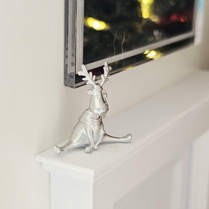 Silver seated christmas reindeer ornament in a 1:12 scale dolls house display, detail view 2