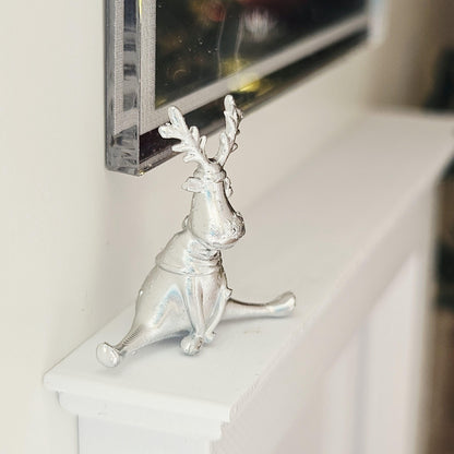 Silver seated christmas reindeer ornament in a 1:12 scale dolls house display, detail view 3