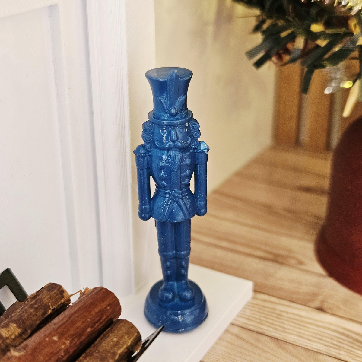 Blue christmas nutcracker ornament in a 1:12 scale dolls house display, detail view 10