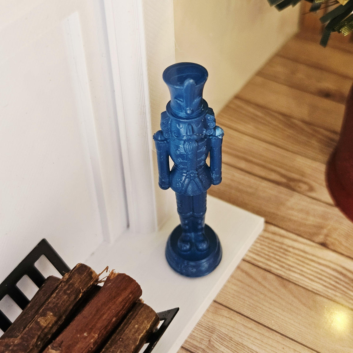 Blue christmas nutcracker ornament in a 1:12 scale dolls house display, detail view 11