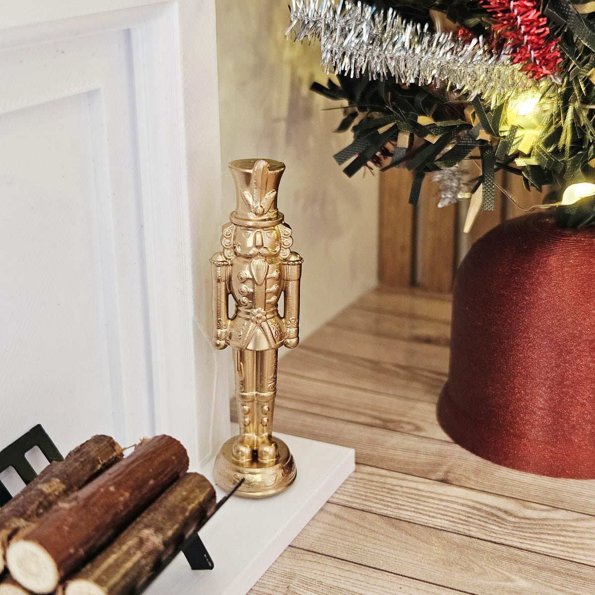 Gold christmas nutcracker ornament in a 1:12 scale dolls house display