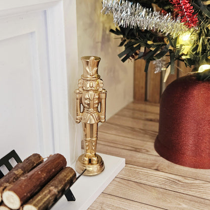 Gold christmas nutcracker ornament in a 1:12 scale dolls house display