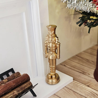 Gold christmas nutcracker ornament in a 1:12 scale dolls house display, detail view 2