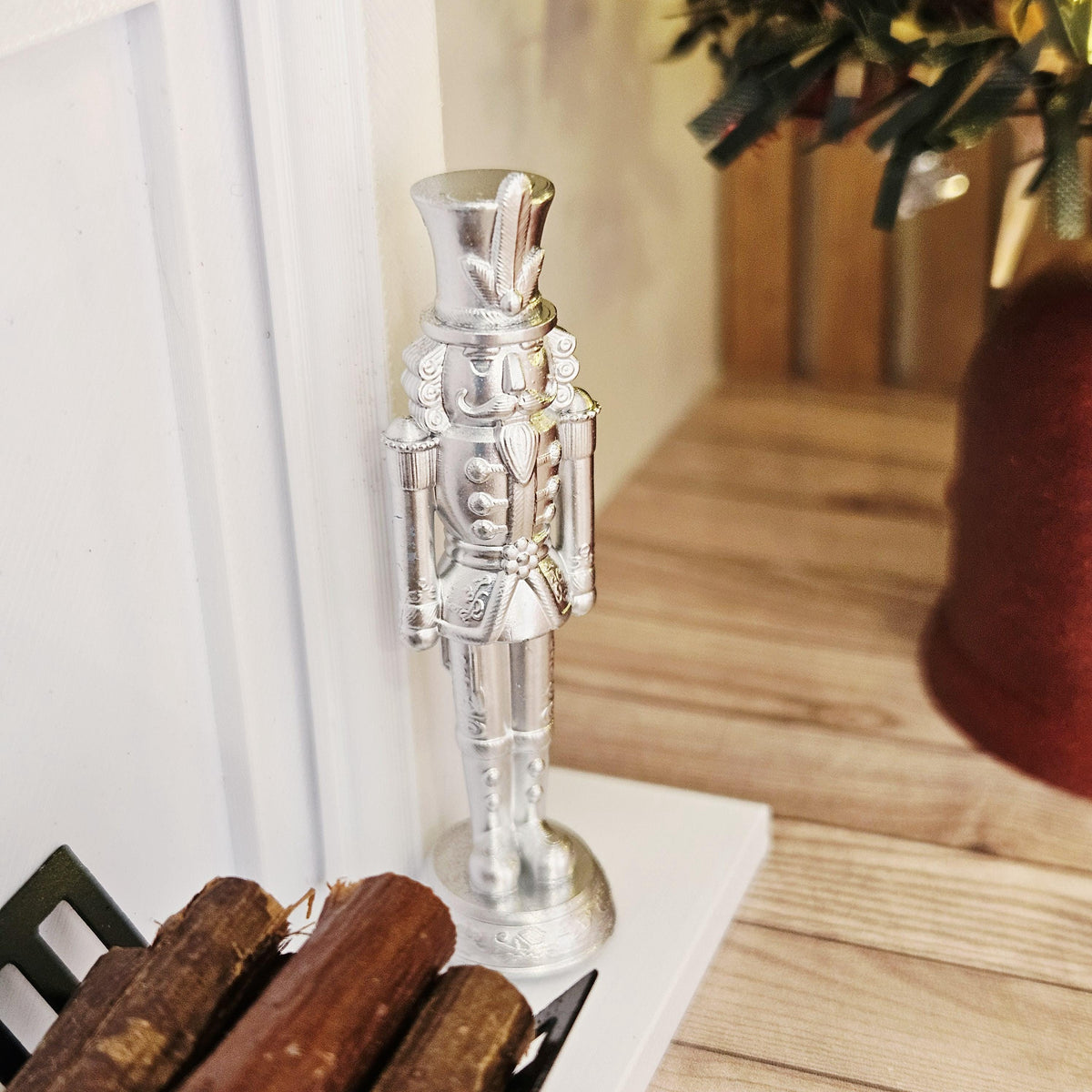 Silver christmas nutcracker ornament in a 1:12 scale dolls house display, detail view 4