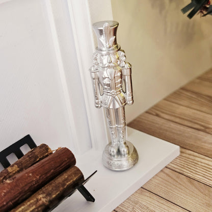 Silver christmas nutcracker ornament in a 1:12 scale dolls house display, detail view 5