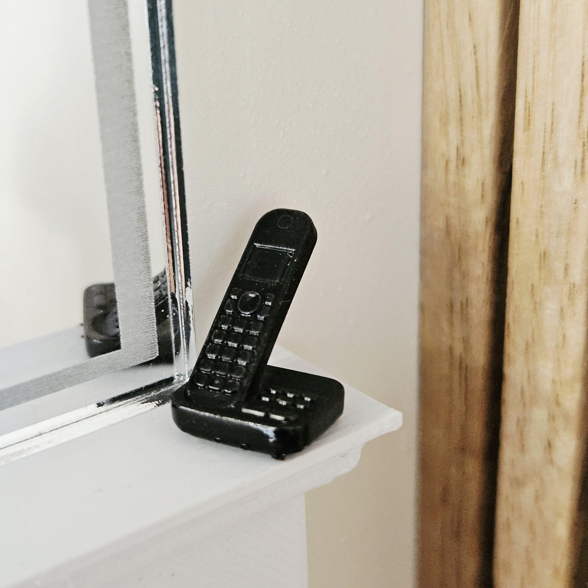 Black modern telephone with answering machine in a 1:12 scale dolls house display, detail view 2
