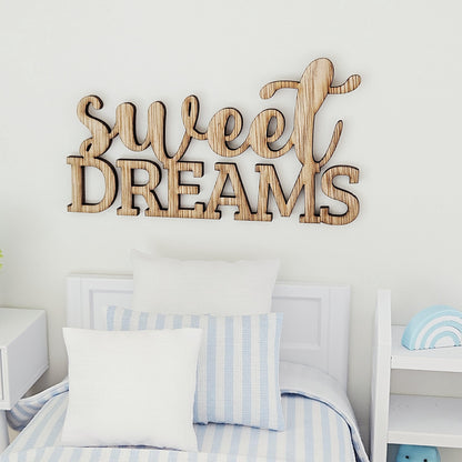 Sweet Dreams wooden sign above a miniature bed with white and blue-striped pillows and a rainbow decoration on adjacent shelving.