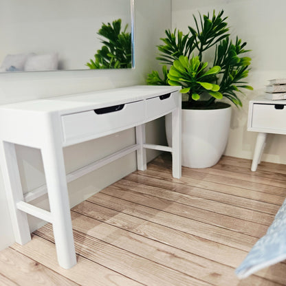 White 1:12 scale dolls house dressing table with two closed drawers and an open frame, front three-quarter view