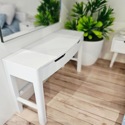 Angled view of the white miniature dressing table, showing the tabletop and recessed drawer pulls
