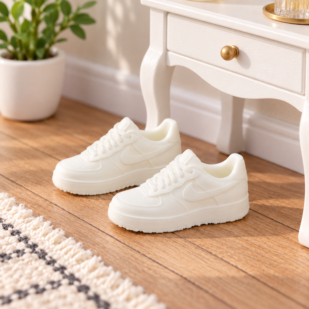 White dolls house trainers beside a miniature dressing table in a 1:12 scale room